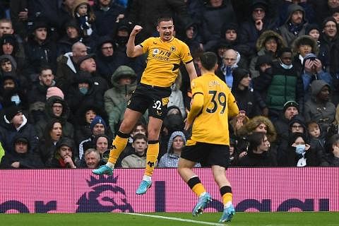 GOL!: Leander Dendocker (kiri) meraikan golnya bersama rakan sepasukan Luke Cundle (kanan) ketika Wolves menang 2-0 ke atas Tottenham kelmarin. - Foto-foto AFP