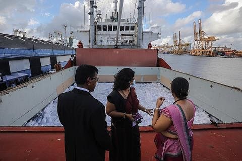 BANTUAN: Pegawai Sri Lanka memeriksa kapal yang membawa bantuan kemanusiaan yang didermakan pemerintah India di pelabuhan Colombo, Sri Lanka. - Foto EPA-EFE