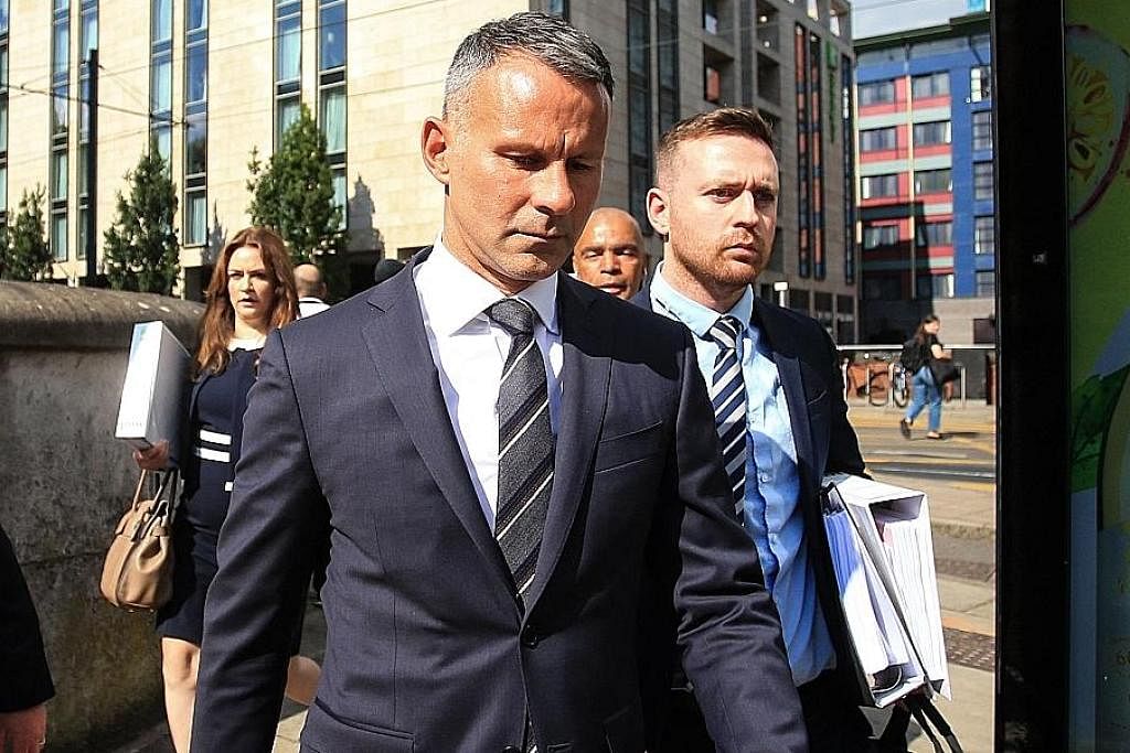 PERTAHAN NAMA: Ryan Giggs (depan) tiba di mahkamah kelmarin bersama pasukan peguamnya bagi perbicaraan atas dakwaan bertindak ganas terhadap bekas temanitanya. - Foto AFP
