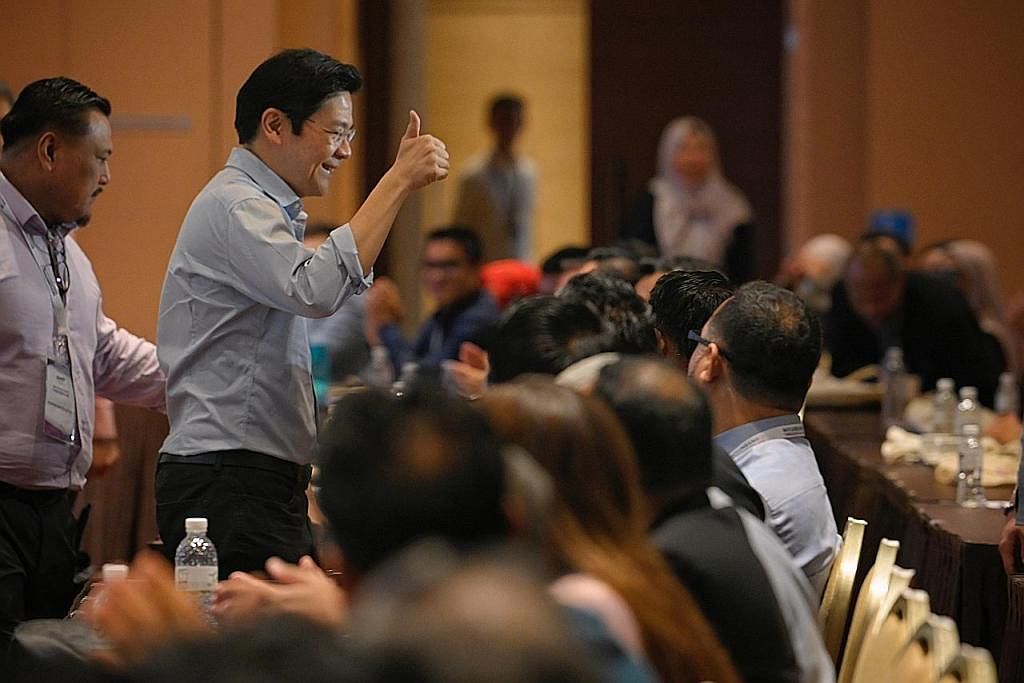 TETAMU TERHORMAT: Timbalan Perdana Menteri, Encik Lawrence Wong, yang dilihat bersama Pengerusi AMP, Dr Md Badrun Nafis Saion (paling kiri), disambut hadirin apabila tiba di Konvensyen Nasional ke-4 AMP yang diadakan di Max Atria @ Singapore Expo sem